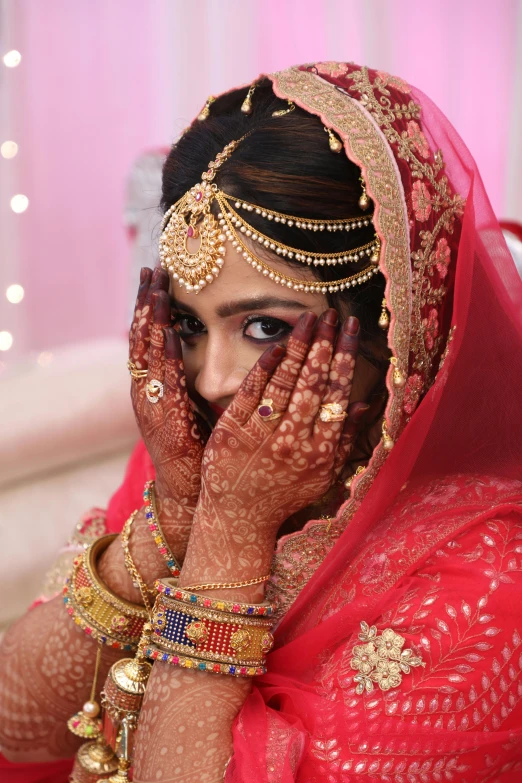 a beautiful young woman in red and gold