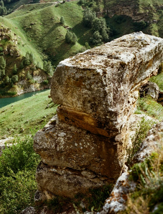 rocks are stacked next to each other in the grass