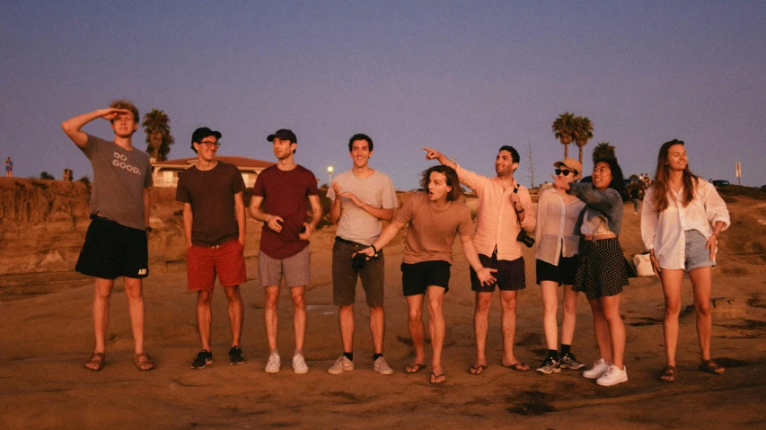 a group of friends posing together in front of a house