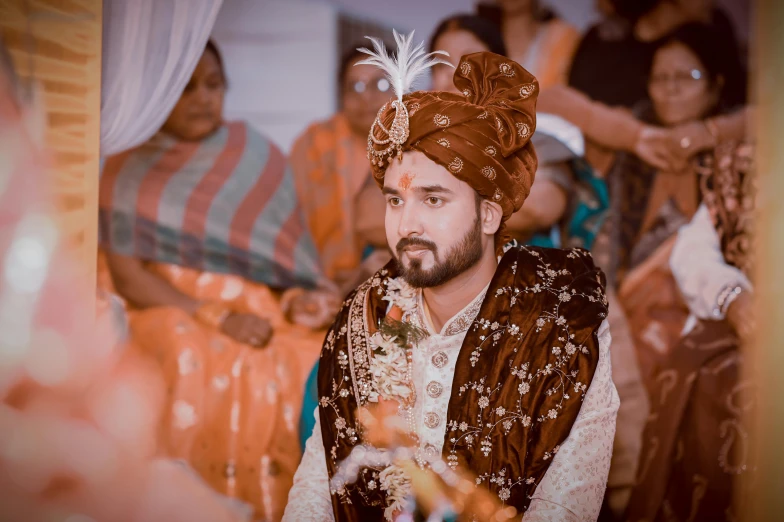 a man in traditional garb with a beard and turban