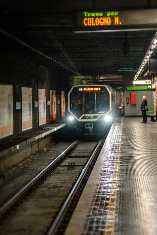 a train coming down the tracks in a subway station