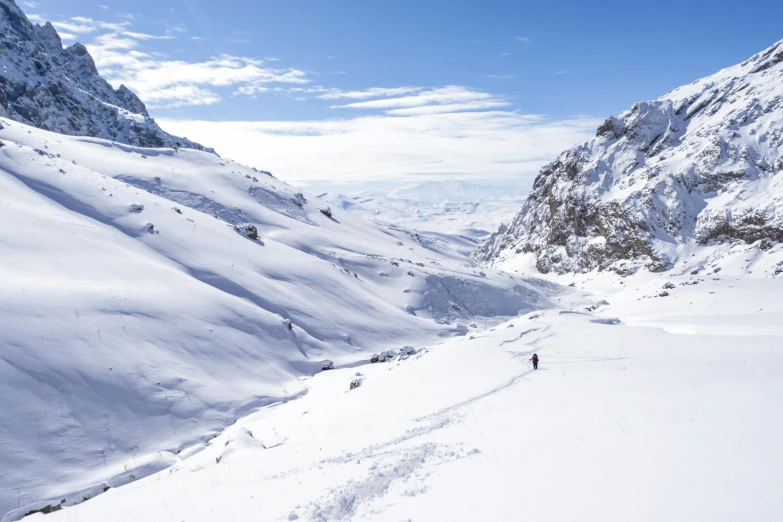 some people are skiing on snow in the mountains