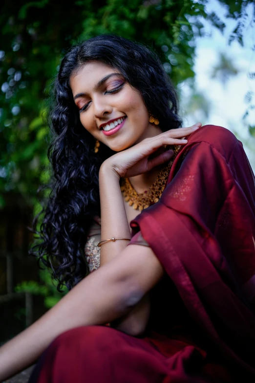 a woman in a red dress sitting in a tree