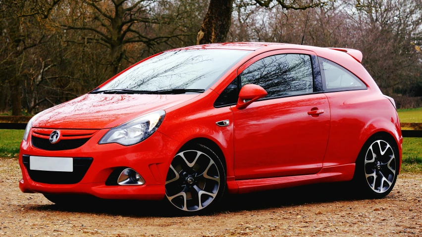 an image of a red car parked in the driveway