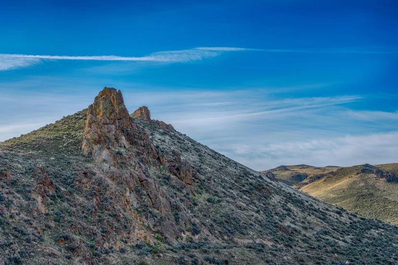 a mountain side with some rocks on the top