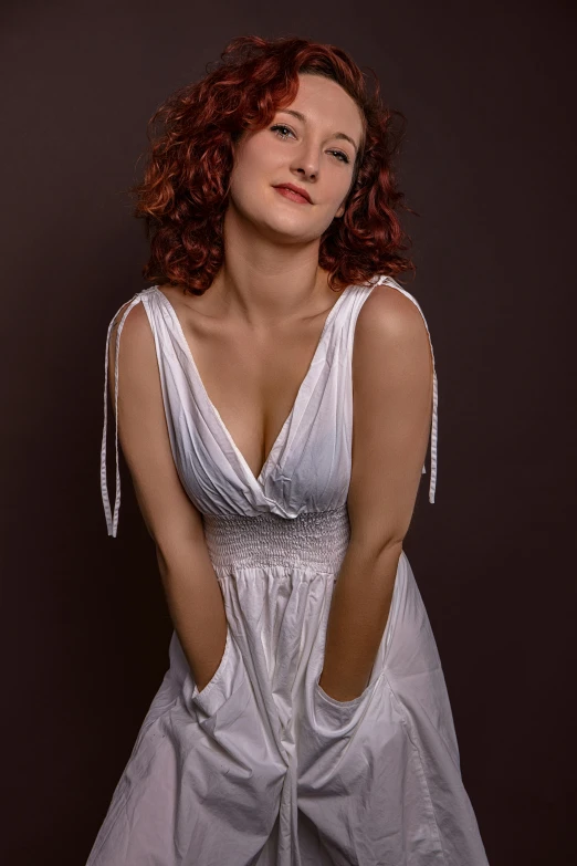 a woman with red hair is wearing a dress