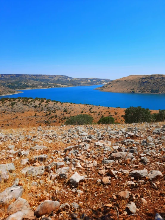 there is a view of some rocks and water from the peak