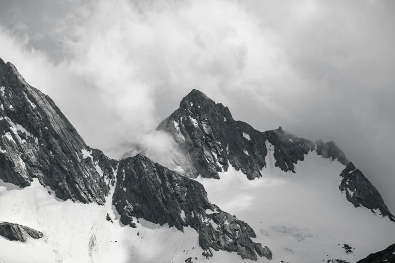 a view of three mountains with a lot of clouds