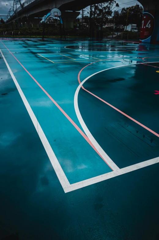 an empty tennis court with the blue paint applied