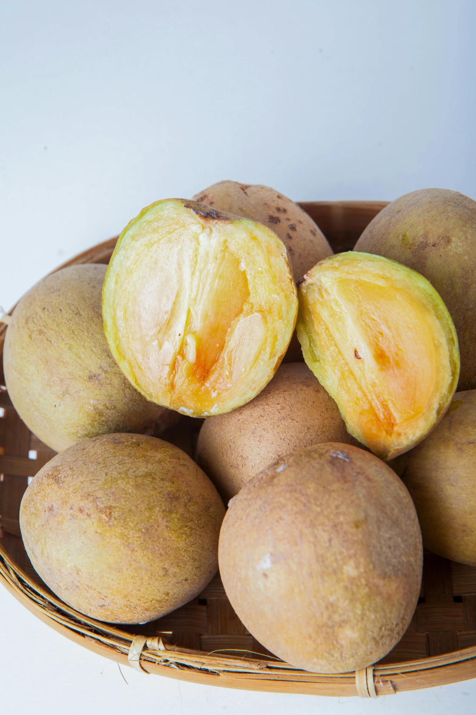 a pile of brown fruit in a basket