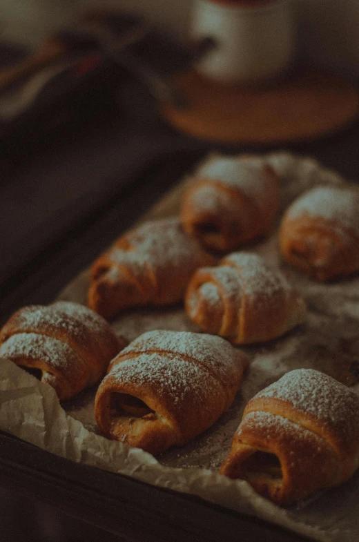 a tray full of powdered pastries on top of a table