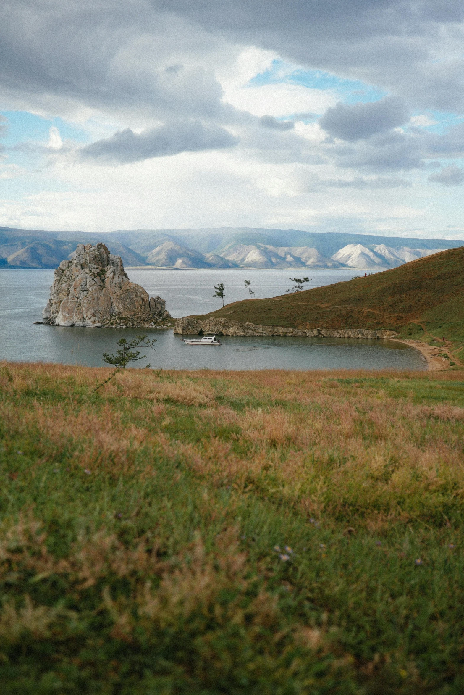 a big rock sits out on the water