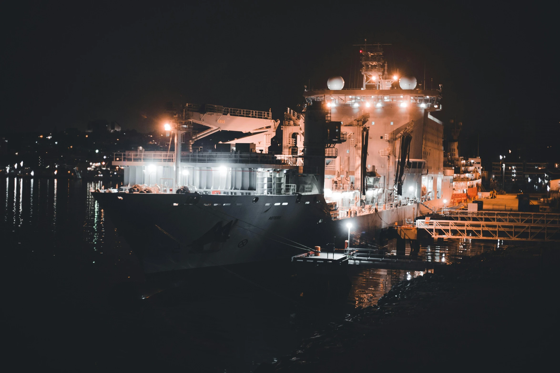 a large cargo ship docked in the middle of a harbor