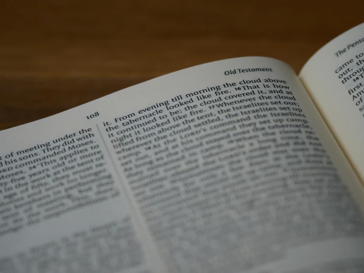 a book opened with two pages in it on a wooden table