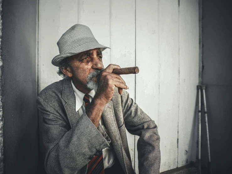 a man in a suit smoking a cigarette