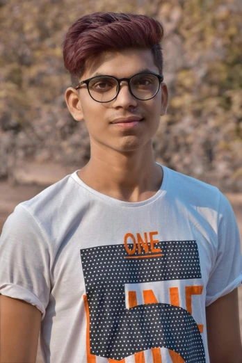 a boy wearing glasses and a tee - shirt