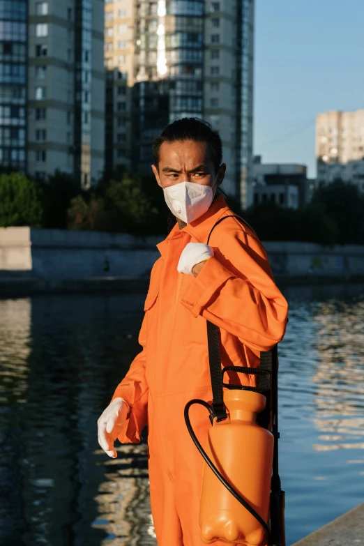 an orange worker wears a face mask to protect herself from the spread
