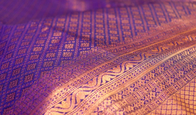 a closeup s of an elaborate yellow and purple cloth