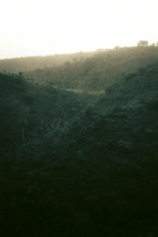 silhouette of a person in the distance walking in the distance on a hilly hillside