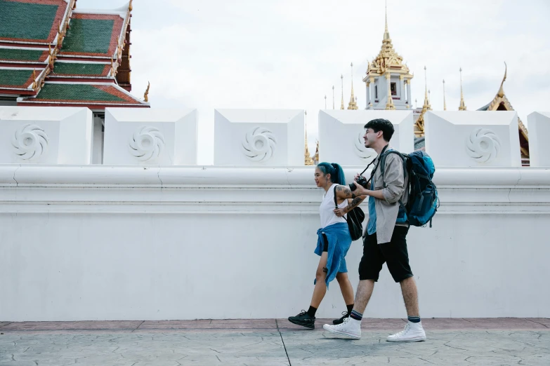 two children walking on the street carrying their backpacks