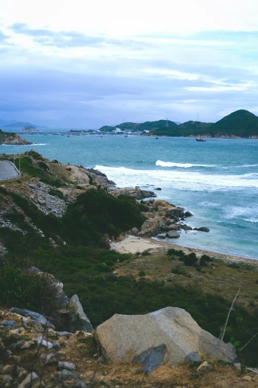 the rocks are near the water and the sky