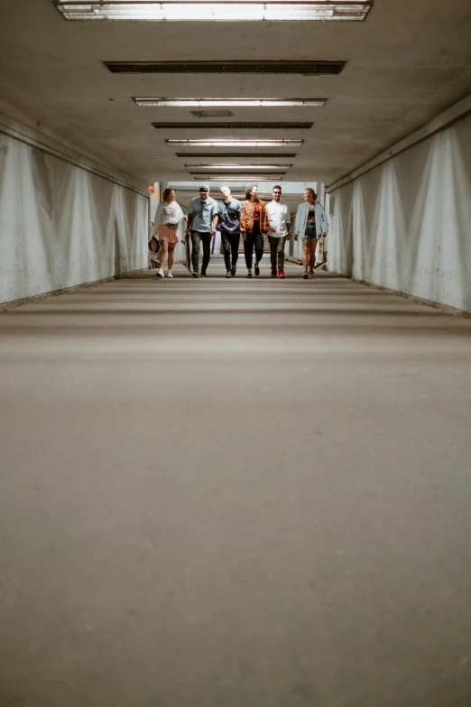 people walking in an alley that looks like it is raining