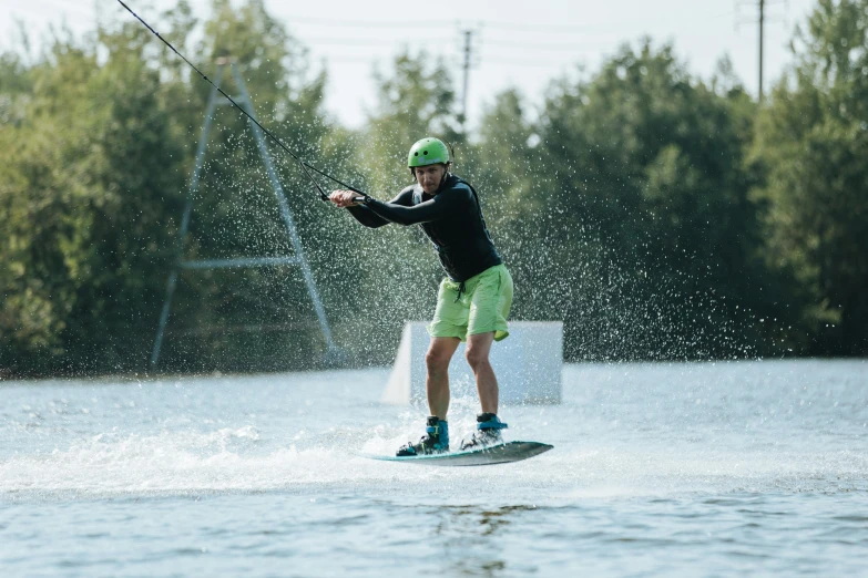 the man is kite surfing on a lake