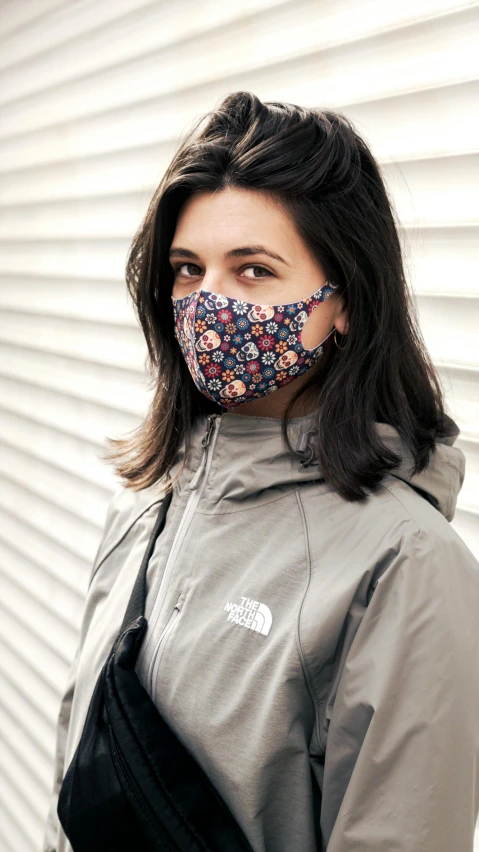 a woman wearing a floral mask with a zipper