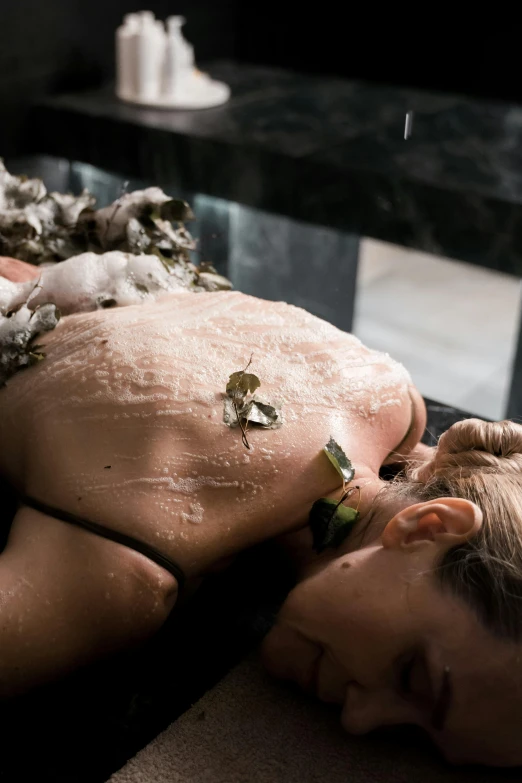 man is relaxing while getting a lot of water and mud off his back