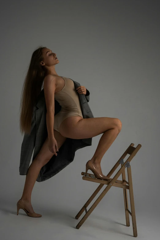 a woman that is sitting on a wooden ladder