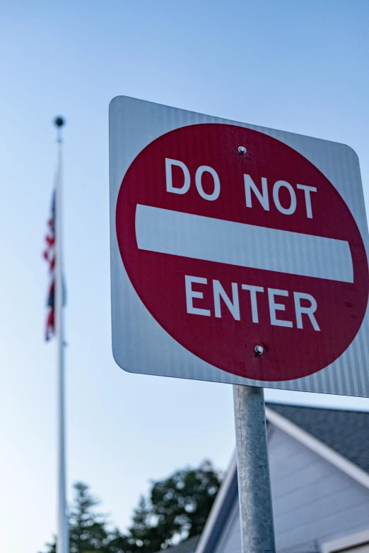 a do not enter sign is in front of a flag