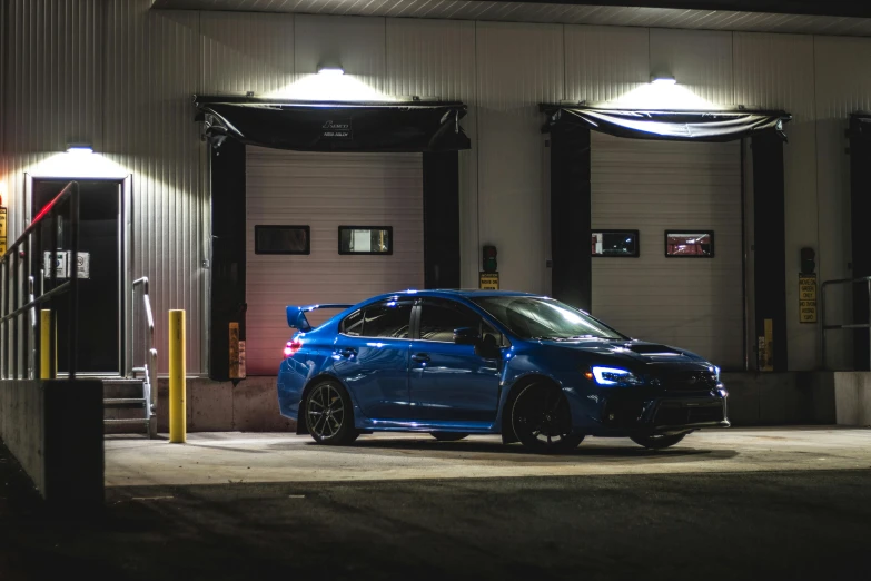 a blue car is parked in front of the building