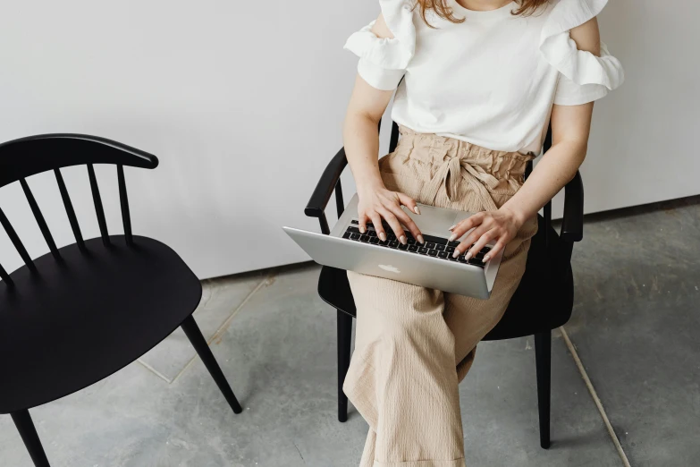 a woman with glasses is using a laptop
