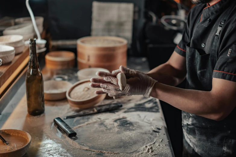 a man in a kitchen holding his hands out