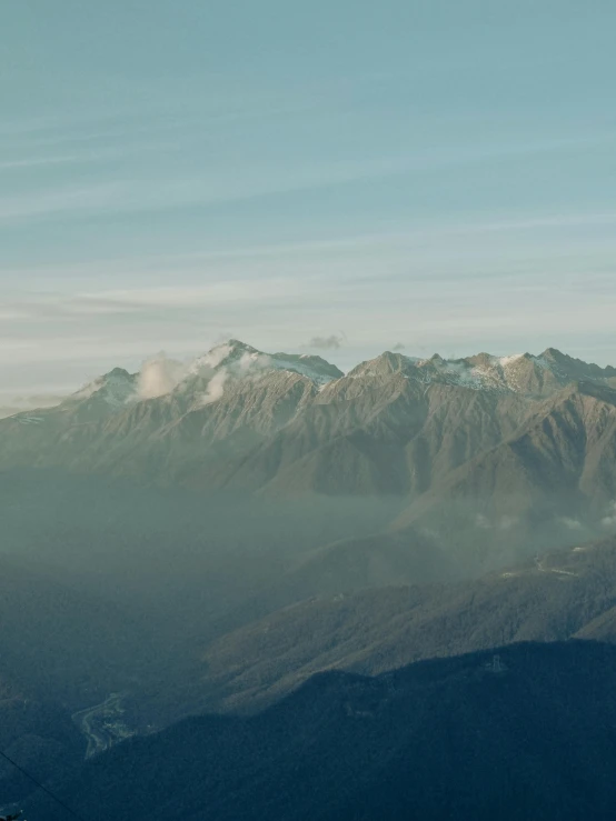 there are some hills and mountains with clouds