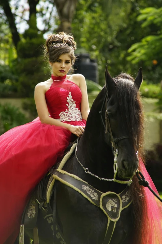  wearing a red gown on horse