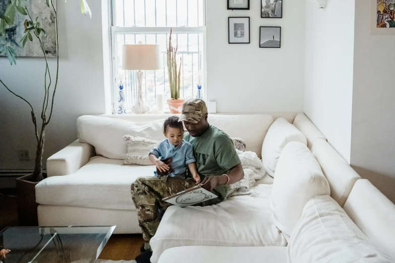 a father reading his son's story in his living room