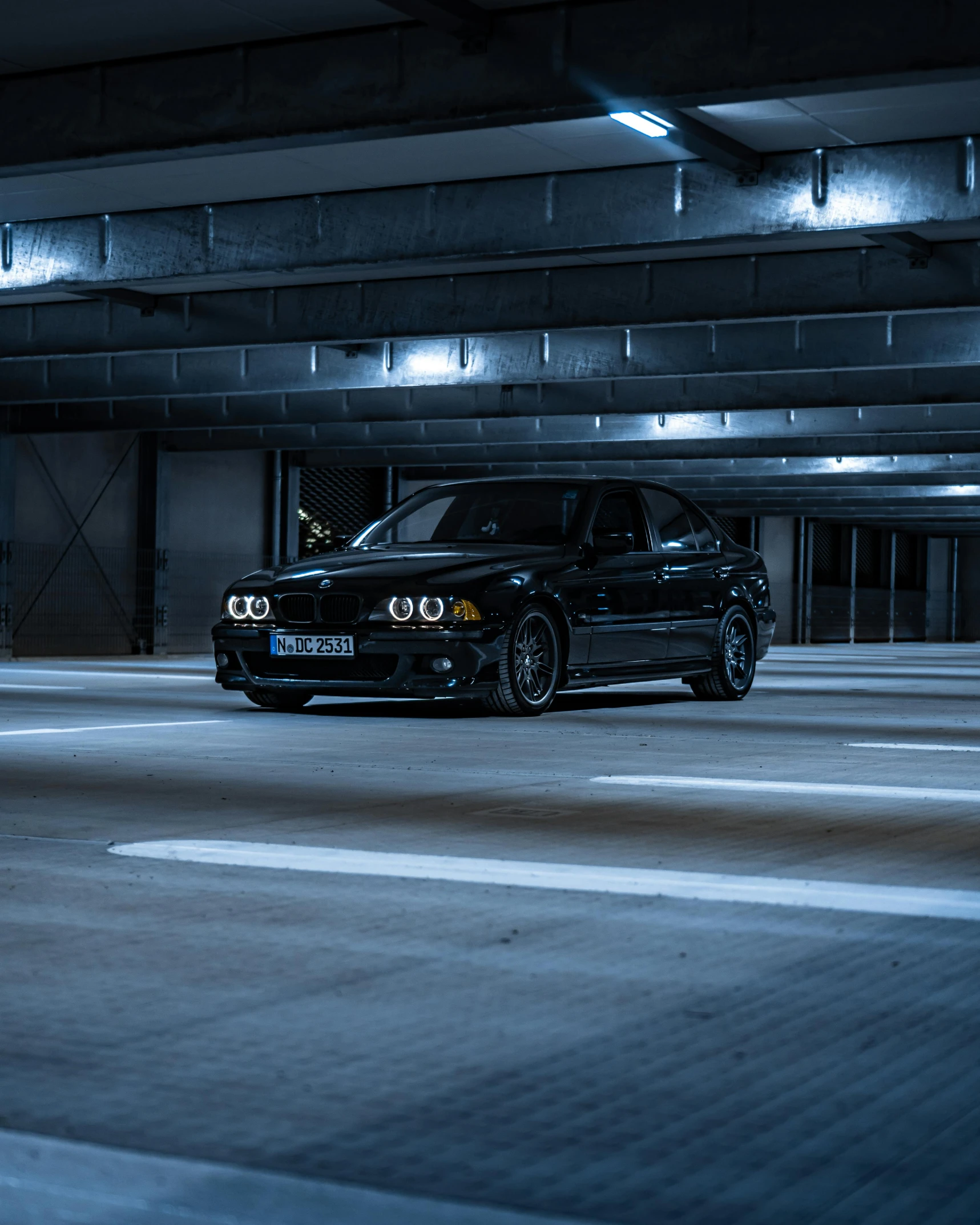 a black car parked in a parking garage