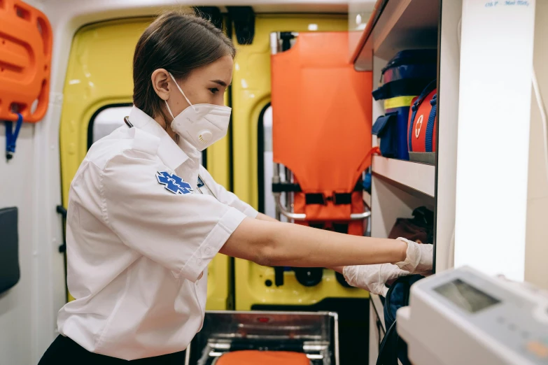 a nurse in an ambulance checking the  of someone