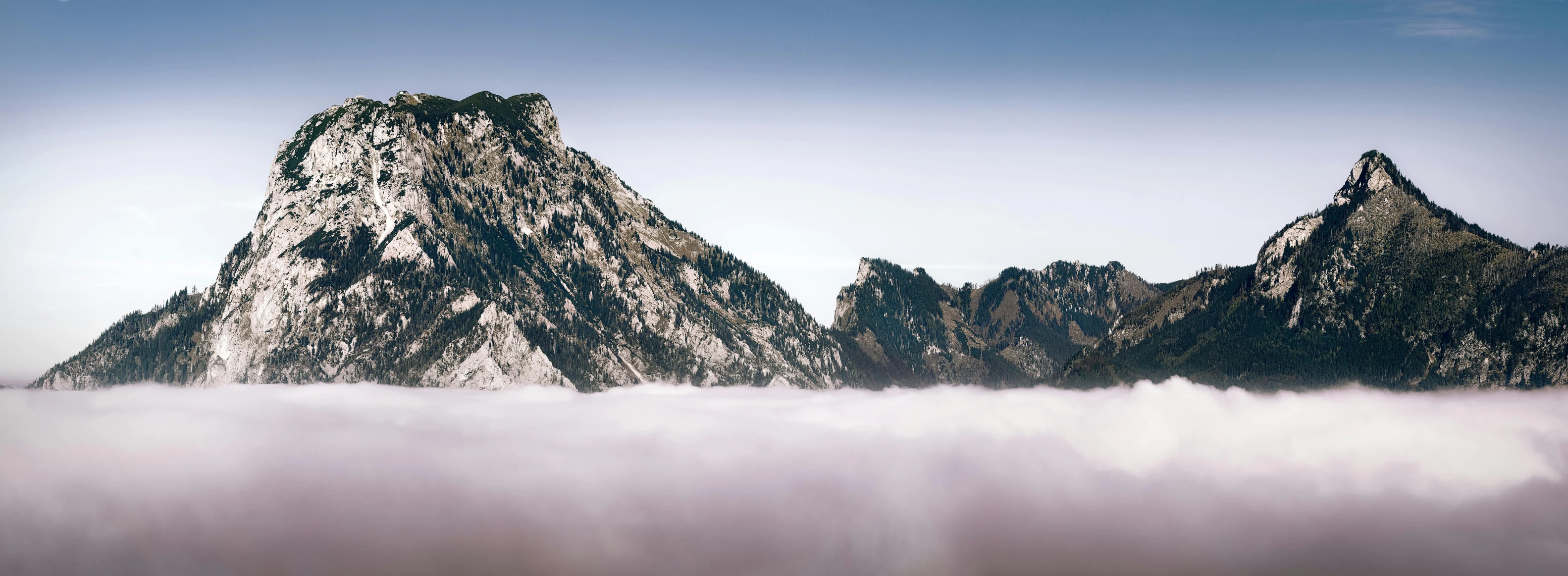 fog covers the mountains and sky as seen from below