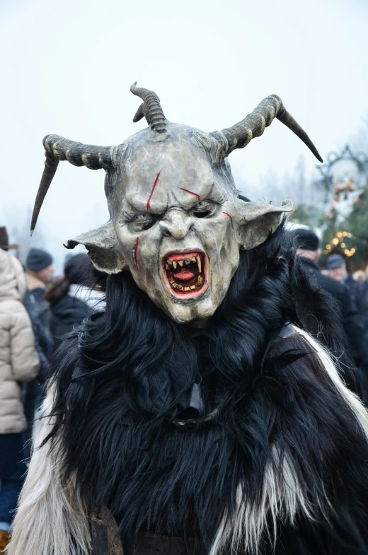 a man in a mask and beard standing near a group