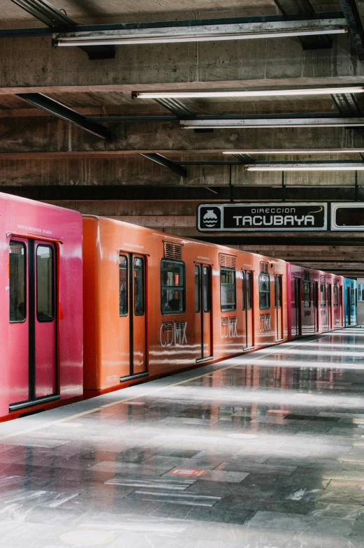 colorful train cars at an underground station in the city