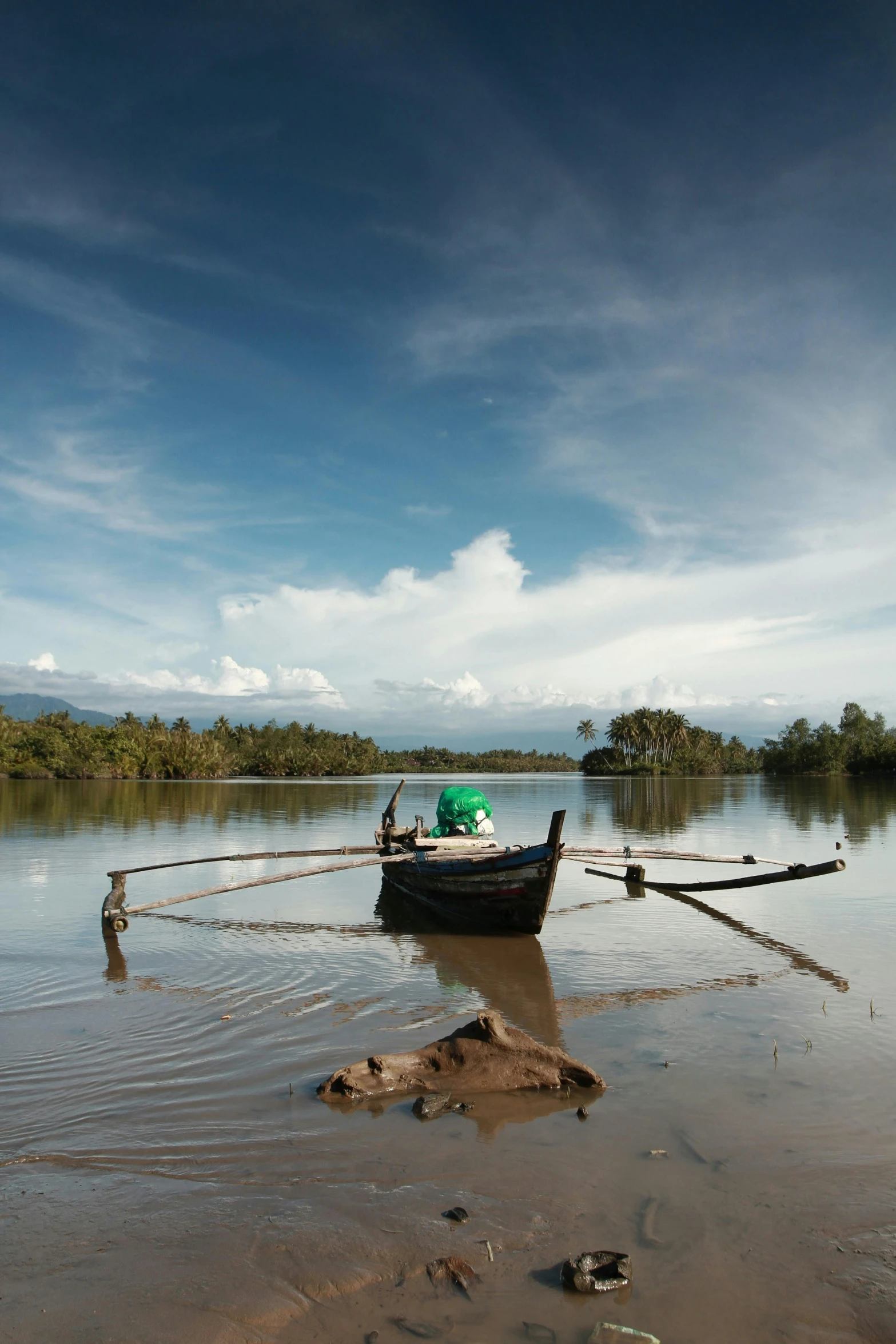 small boat tied up to a wire in the water