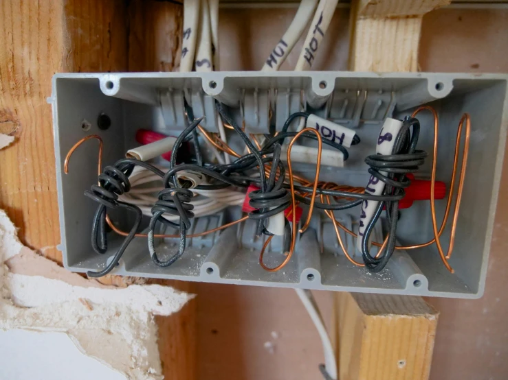 electrical wires and wire hooks in a metal box