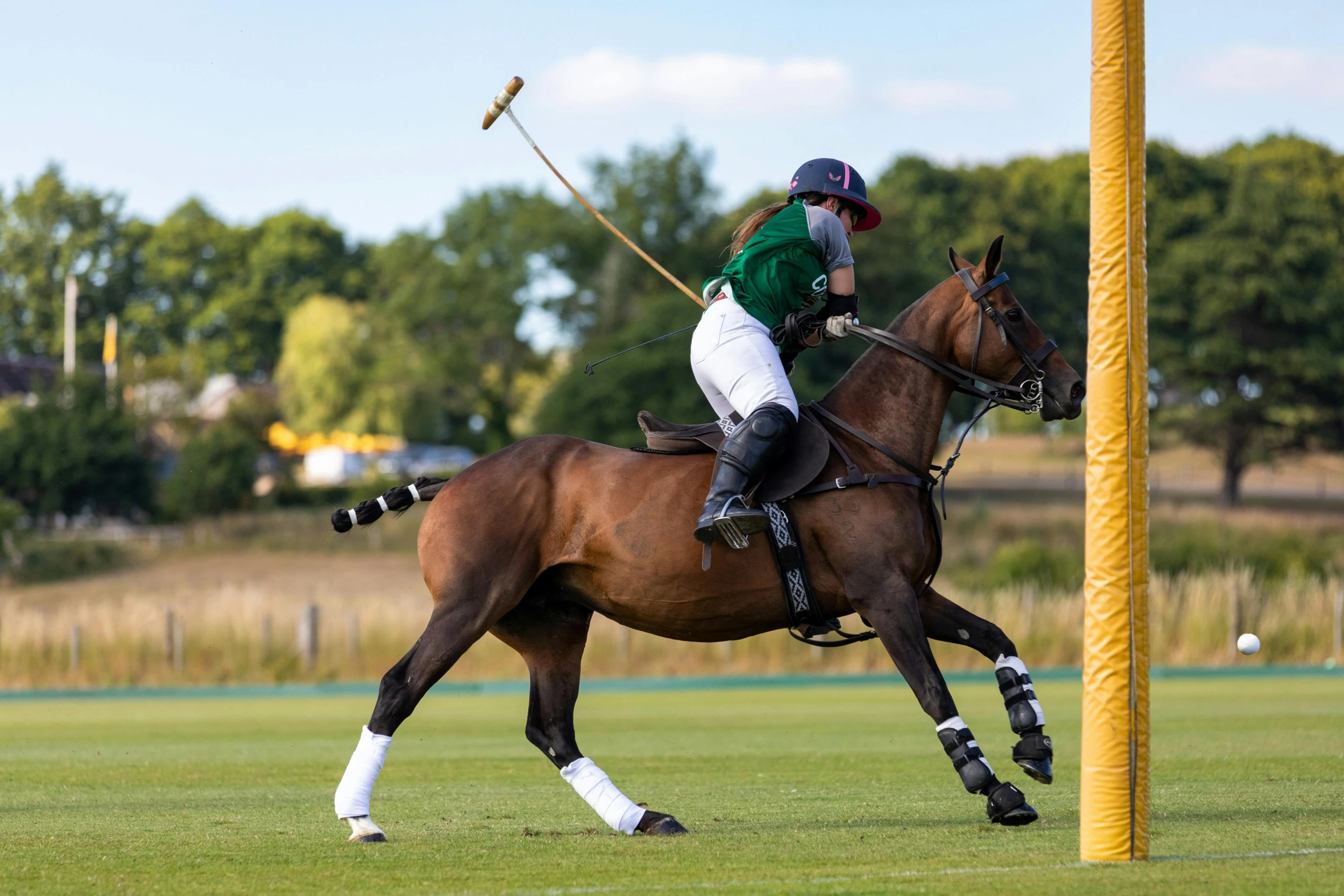 a person wearing a helmet riding a horse