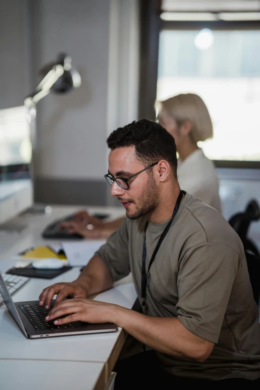 a man sitting at a desk with his laptop