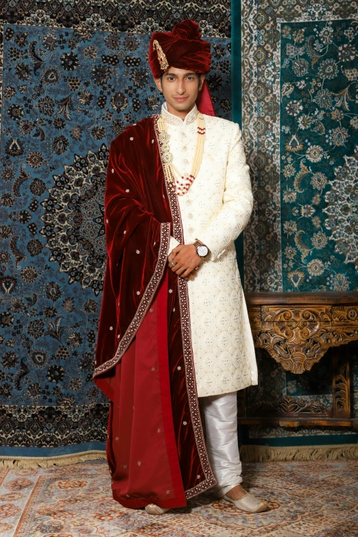 a young man in a traditional indian dress and sherwa with traditional jewelry