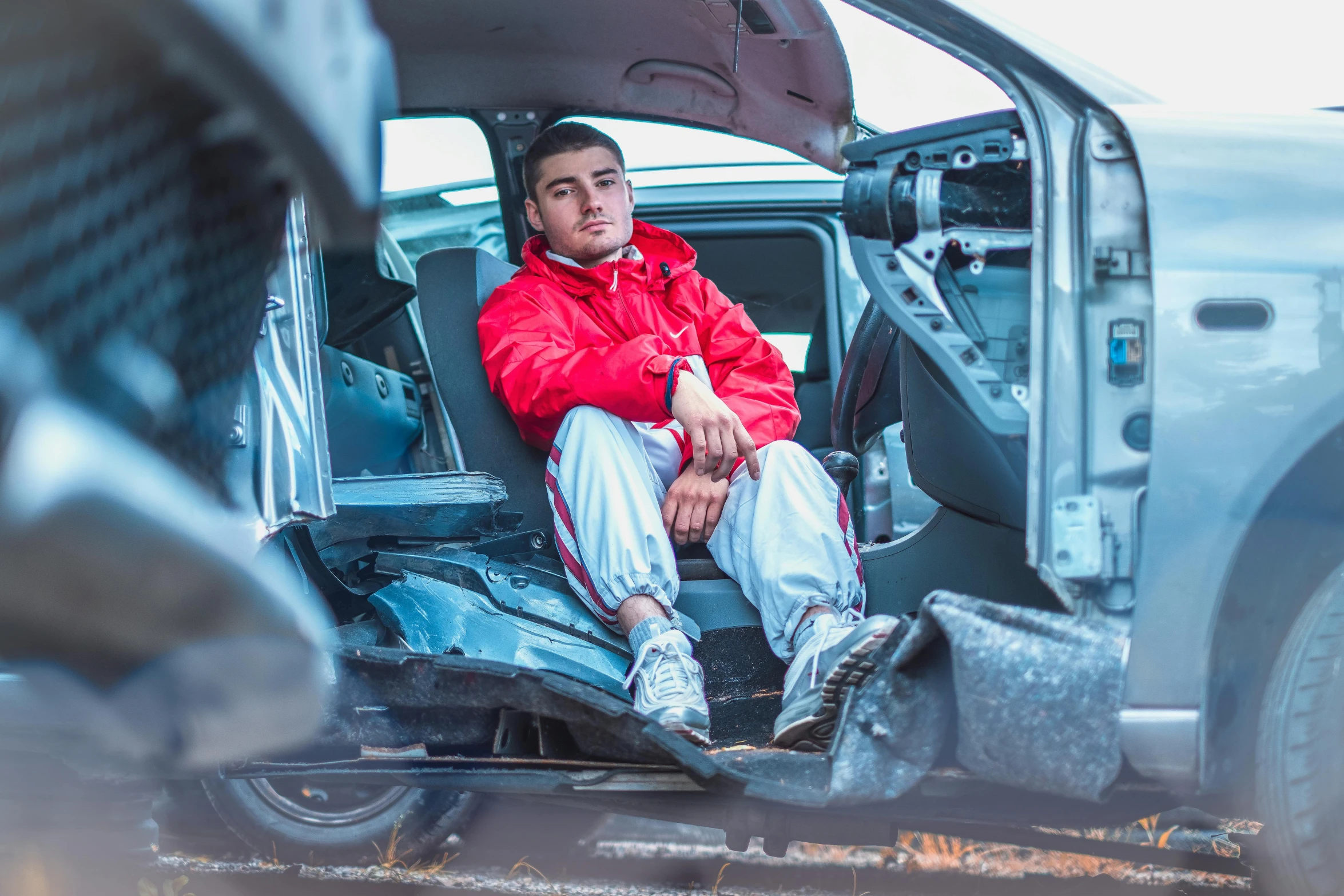 the man is sitting in his vehicle with his feet inside the door