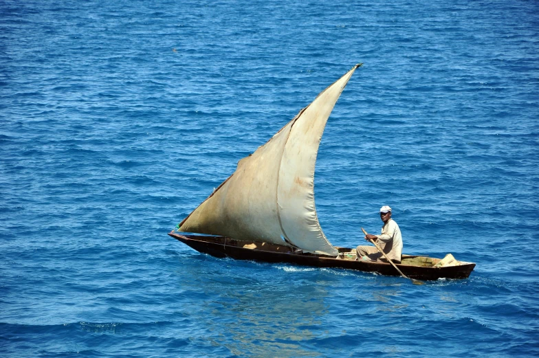 a man on a small boat in the ocean