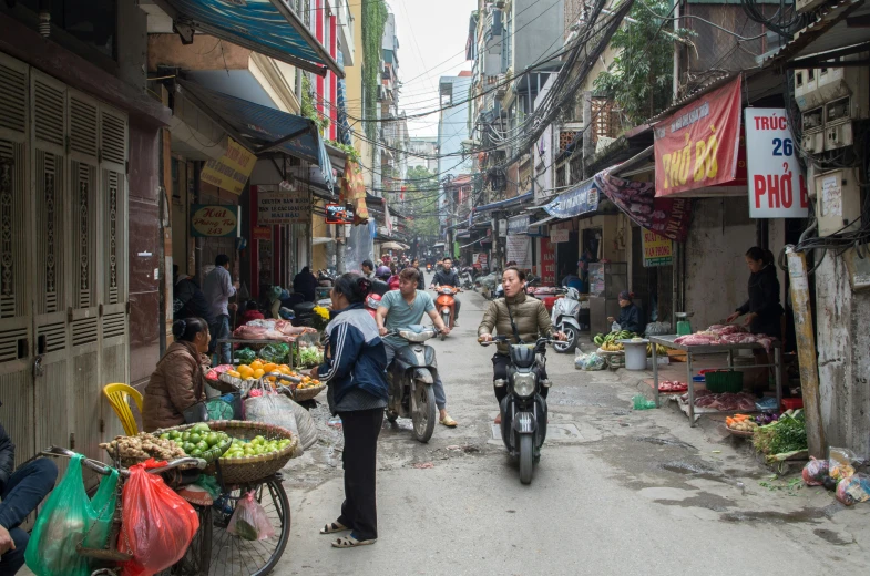 a busy street with people and produce